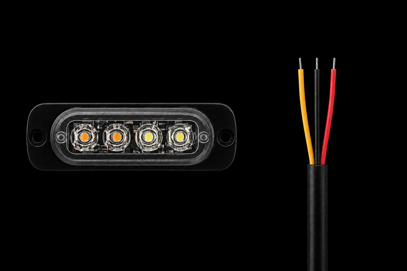 A black rectangular LED light module with four illuminated LEDs on the front, shown next to a black cable with three exposed wires in yellow, white, and red against a solid black background.