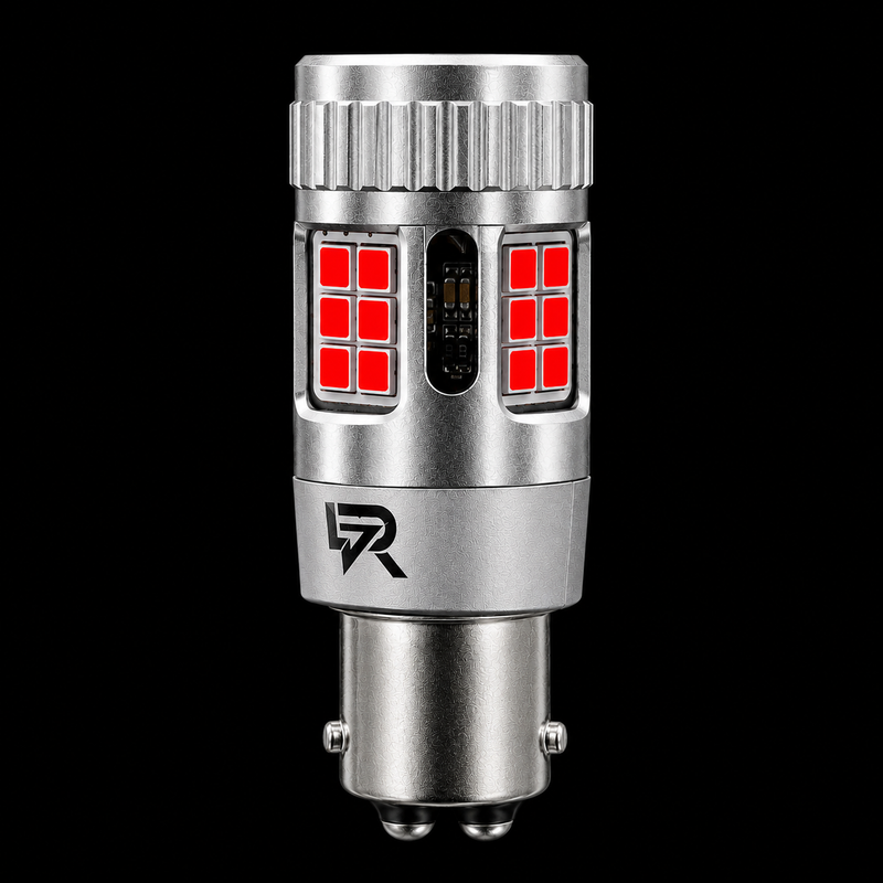 A silver metal automotive LED light bulb with red illuminated LED panels on the front, shown against a solid black background. A stylized 'R' logo is visible on the lower section of the bulb.
