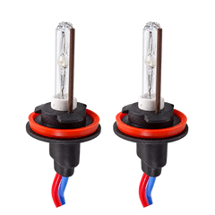 Two car headlight replacement bulbs with clear glass envelopes, visible filament structures, red rubber O-rings, black plastic bases, and red-and-blue wire leads, shown on a plain white background.