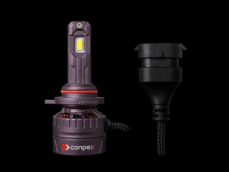 A Conpex LED automotive light bulb shown next to its black electrical connector plug on a solid black background.