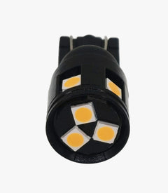 A small black LED light bulb with three visible yellow-gold LED chips on the front, shown against a plain white background.