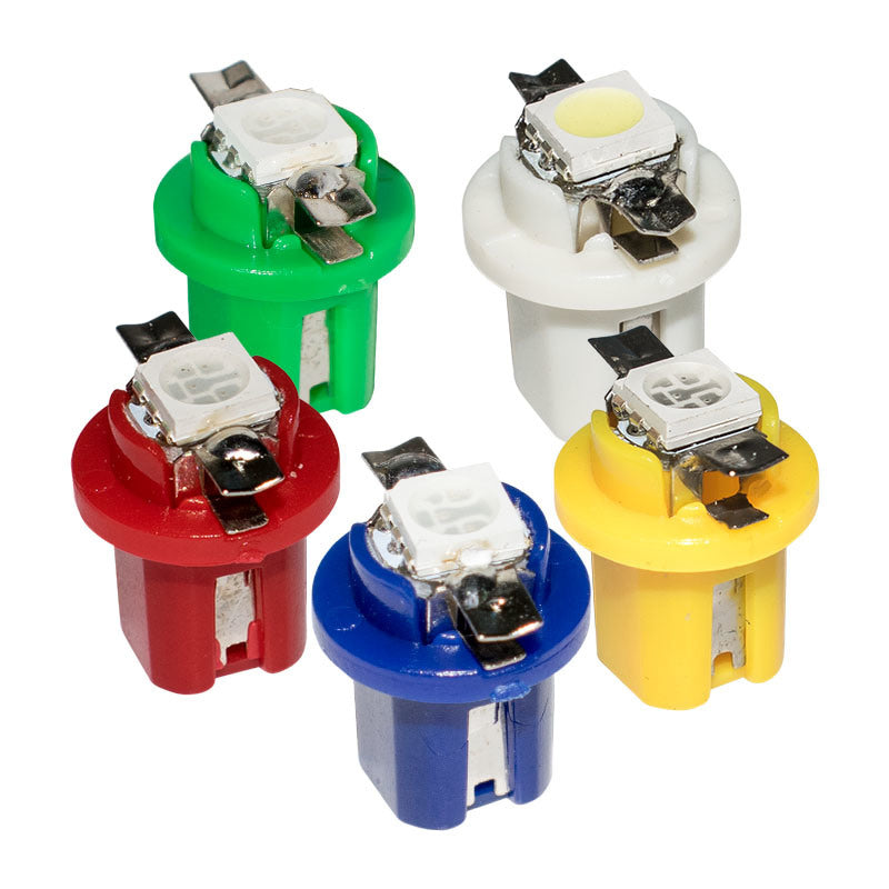 Five small LED light bulbs in different colors (green, white, red, blue, and yellow) arranged on a plain white background.
