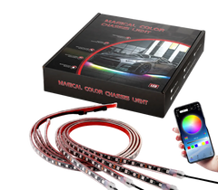 Magic Color Chase LED light strip shown with its black retail box, coiled flexible strip, and a hand holding a smartphone app controller on a transparent/checkered background.